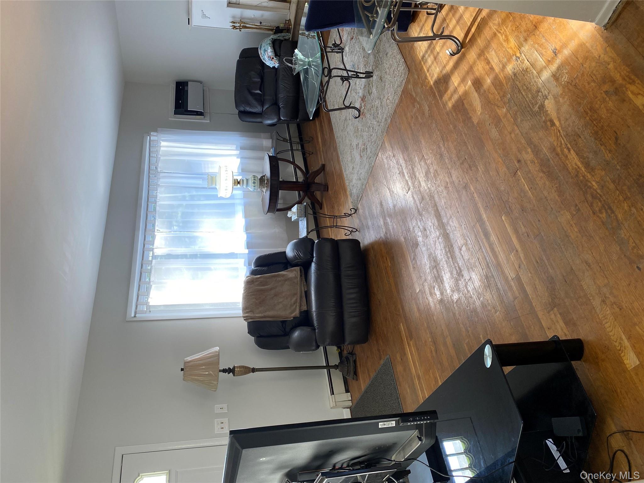 433 Browns Road Nesconset, NY 11767 - Photo 6 of 47 a living room with furniture a window and a flat screen tv