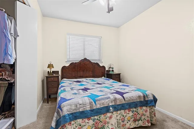 a bedroom with a bed and a tv