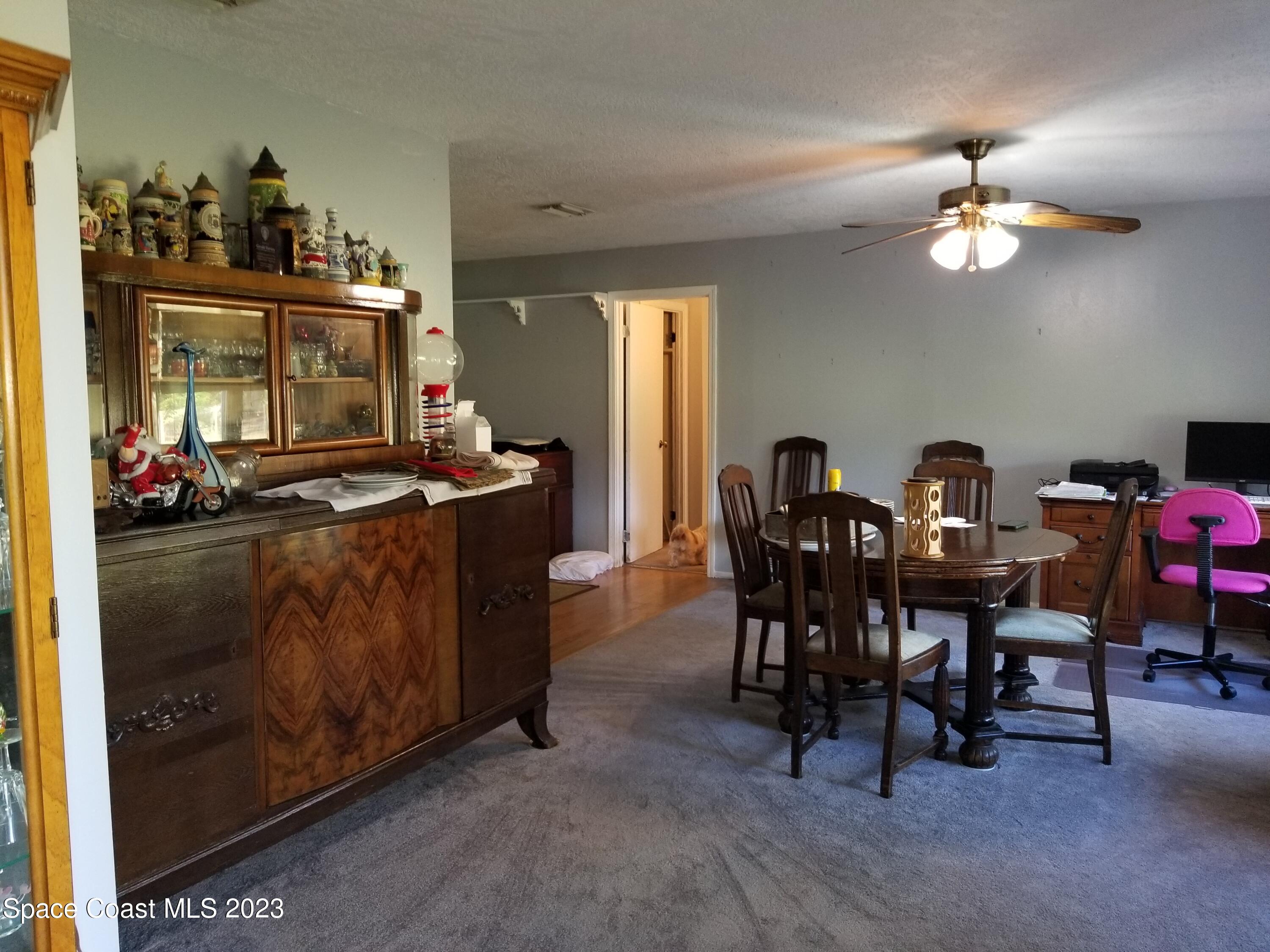 3700 Pine Cone Road Melbourne, FL 32934 - Photo 10 of 38 a view of a dining room with furniture and chandelier