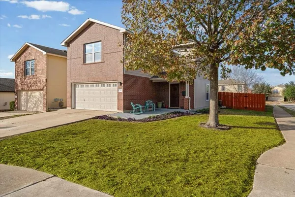 a view of a house with backyard and sitting area