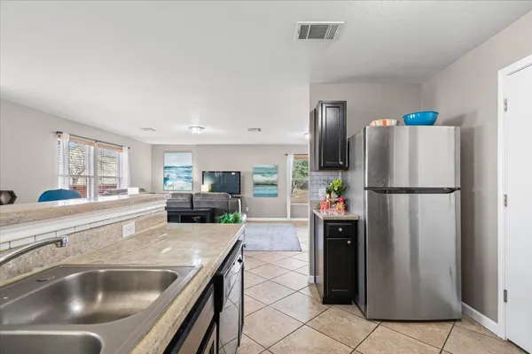 a kitchen with refrigerator and car