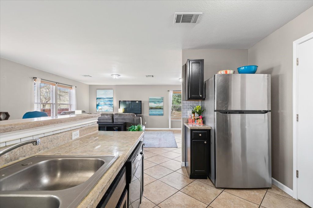 283 Black Forest Road Buda, TX 78610 - Photo 14 of 29 a kitchen with refrigerator and car