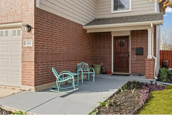 a wooden bench sitting in front of a house