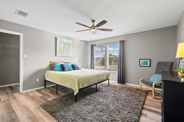 a bedroom with a bed and wooden floor