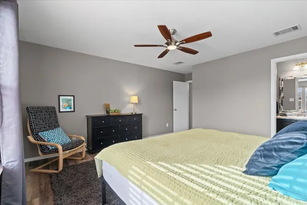 a bedroom with a bed and a dresser