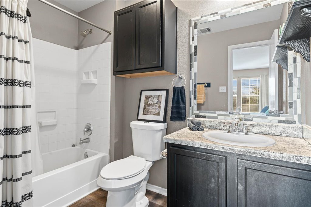 283 Black Forest Road Buda, TX 78610 - Photo 24 of 29 a bathroom with a granite countertop sink toilet and shower