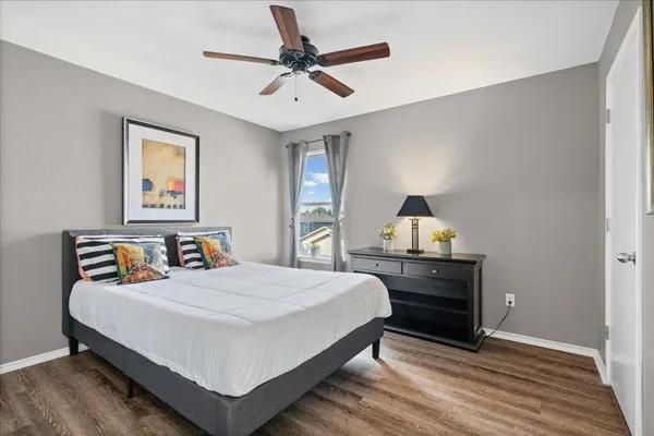 a bedroom with a bed and a chandelier