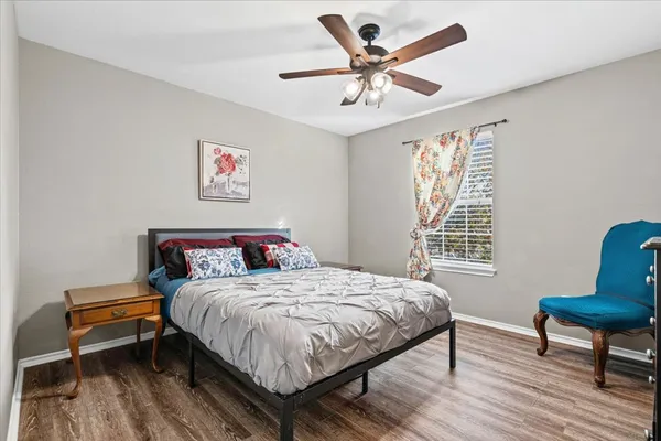 a bedroom with a bed a table and a chair