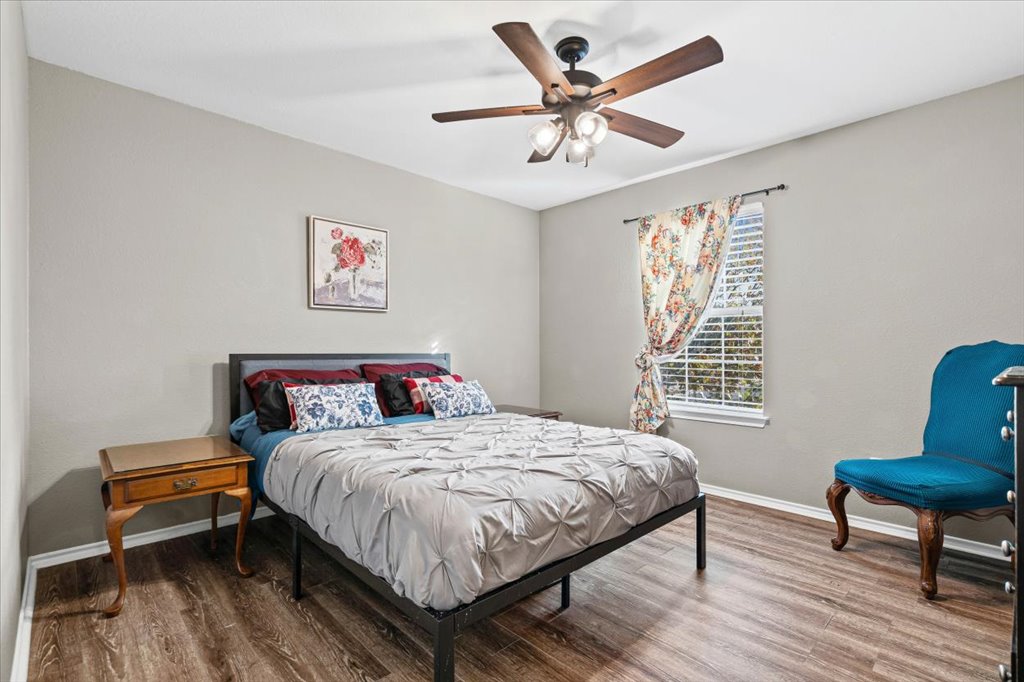 283 Black Forest Road Buda, TX 78610 - Photo 29 of 29 a bedroom with a bed a table and a chair