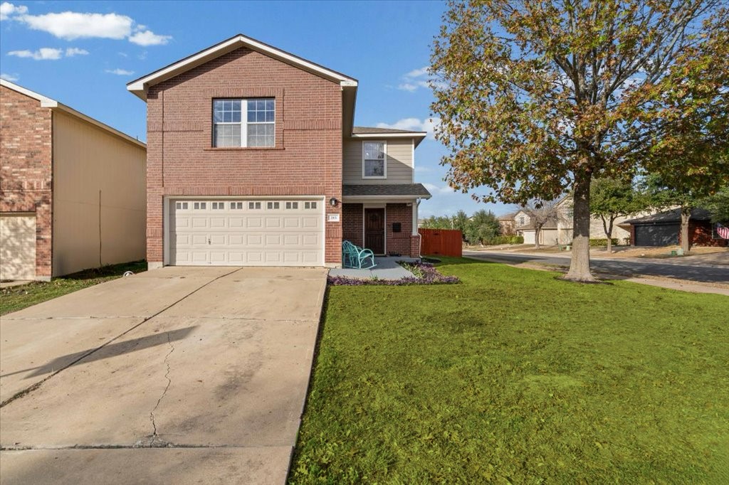 283 Black Forest Road Buda, TX 78610 - Photo 3 of 29 Traditional-style home with brick siding, driveway, and an attached garage