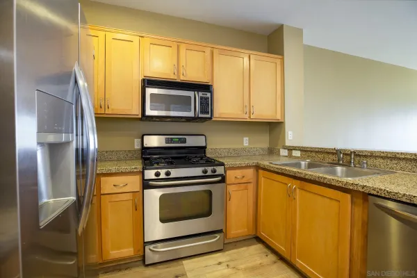 a kitchen with a stove microwave and sink