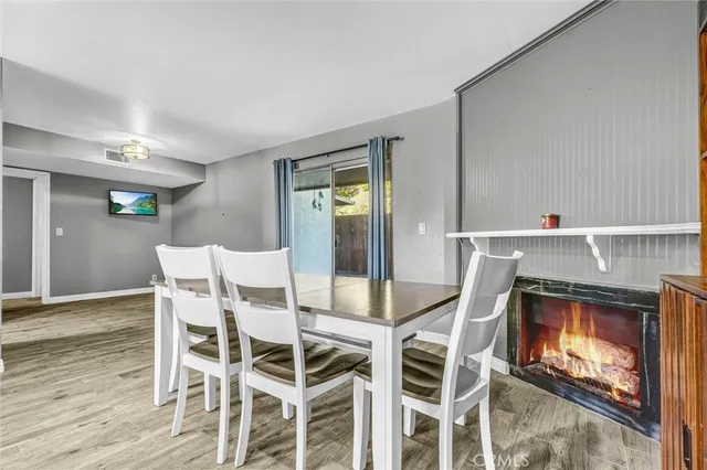 a dining room with a wooden table and chairs