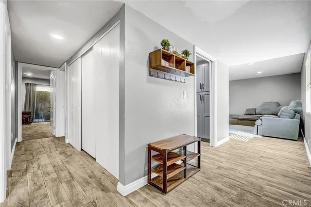 a bedroom with furniture and a wooden floor
