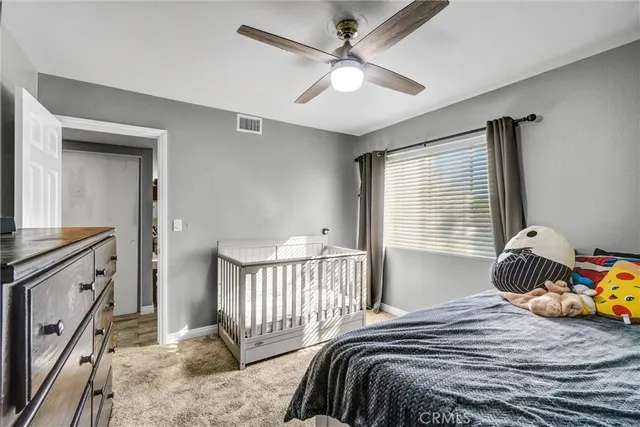 a bedroom with a bed and a tv on the dresser