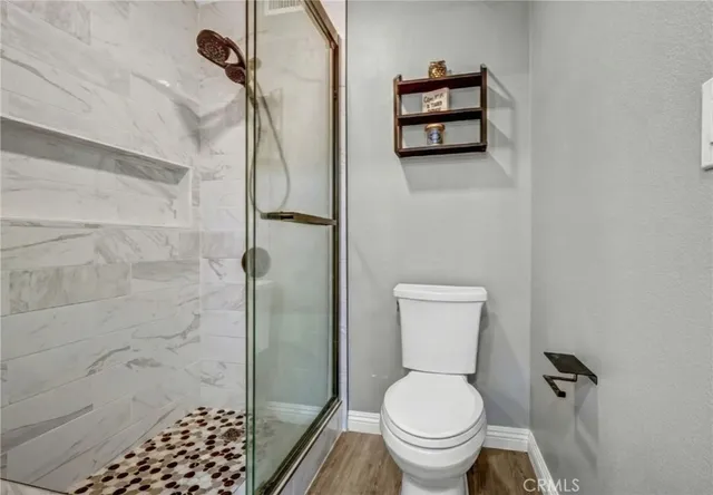 a bathroom with a toilet and a shower