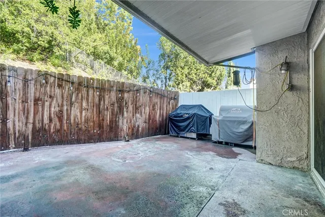 a view of a backyard with wooden fence