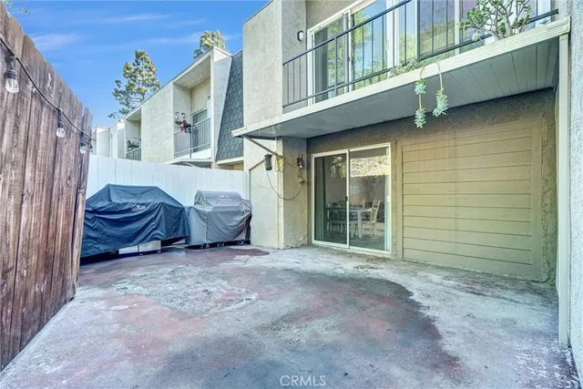 a view of a house with a balcony and wooden fence