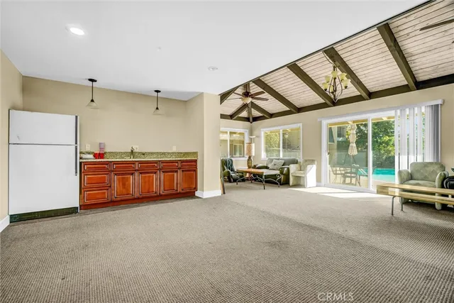a view of a livingroom with furniture and staircase