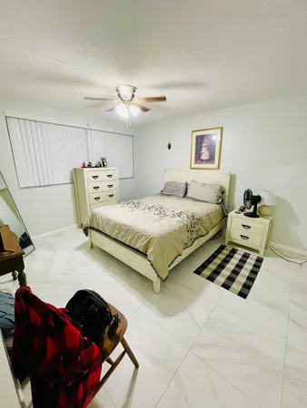 a bedroom with bed and a chandelier