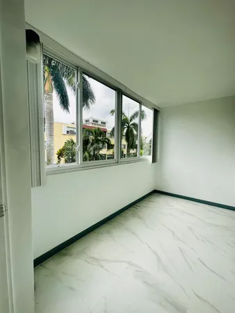 an empty room with large windows