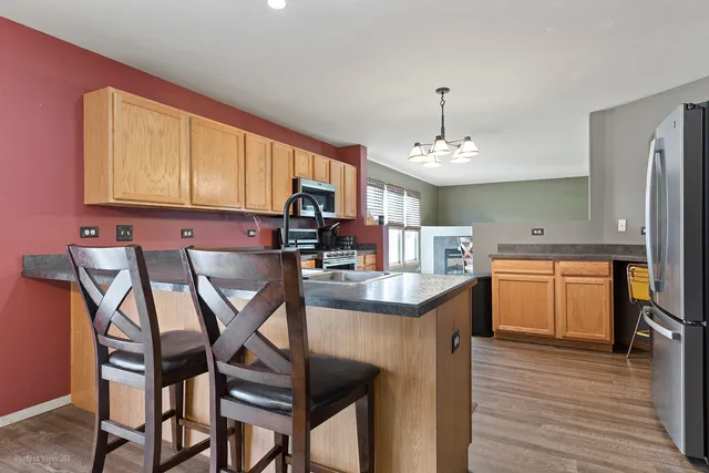 a kitchen that has a cabinets counter space dining table and a sink