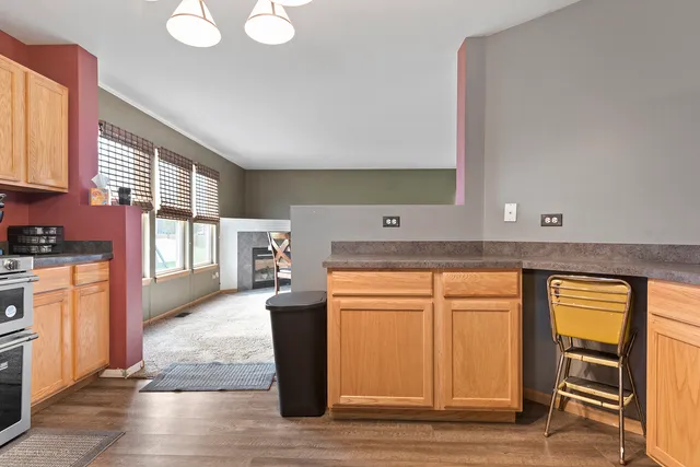 a kitchen with stainless steel appliances granite countertop a stove a sink and a refrigerator