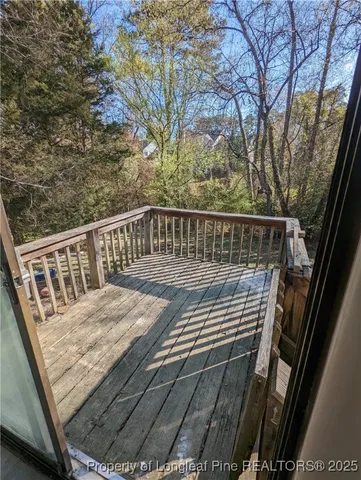 a view of balcony with wooden floor and fence