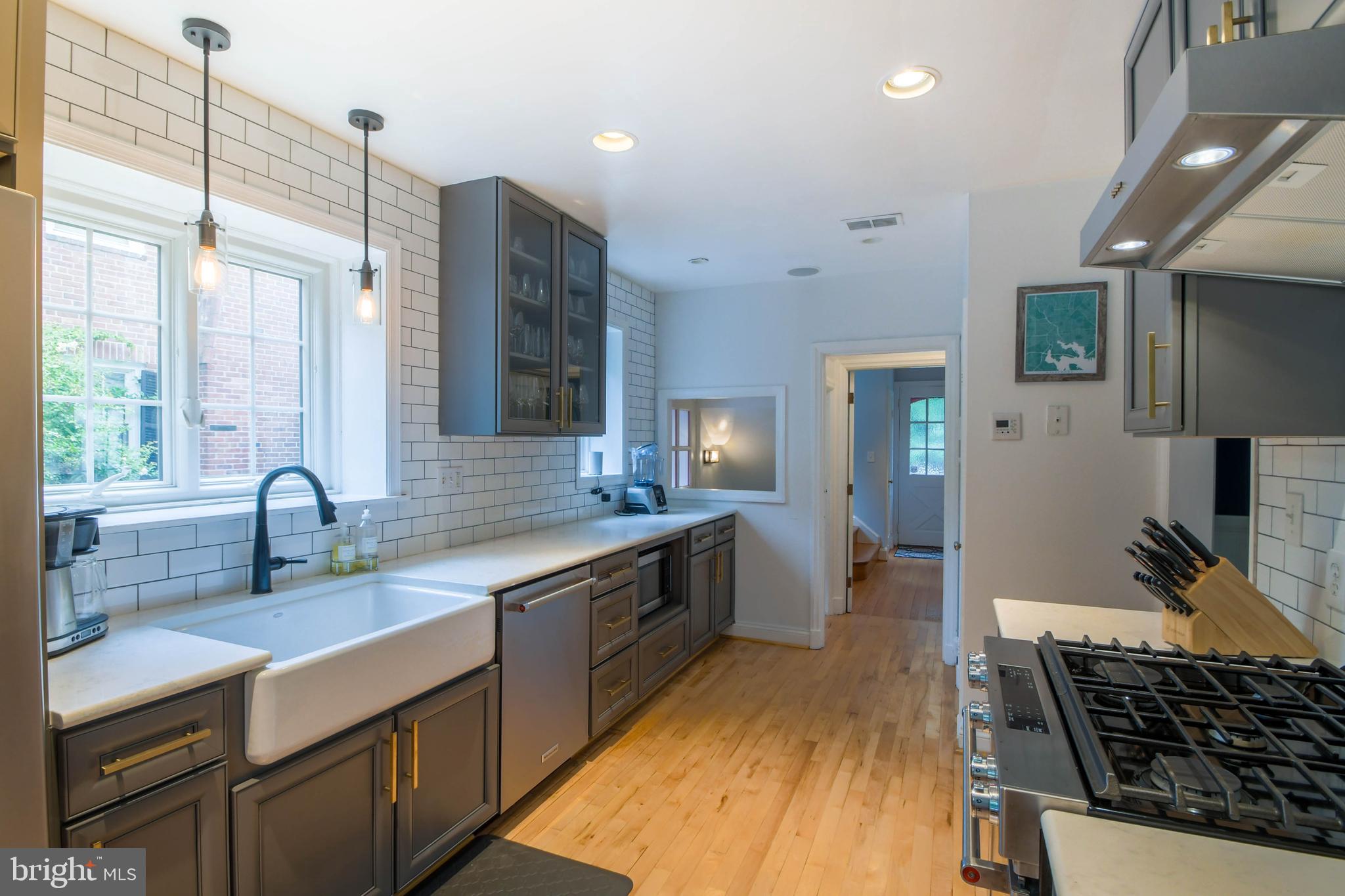 5708 Kenmore Road Baltimore, MD 21210 - Photo 8 of 38 a kitchen with a sink stove and cabinets