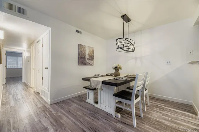 a view of a dining room with furniture wooden floor and a chandelier