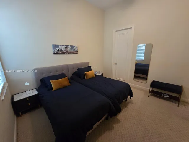 a bedroom with a bed and a lamp on desk