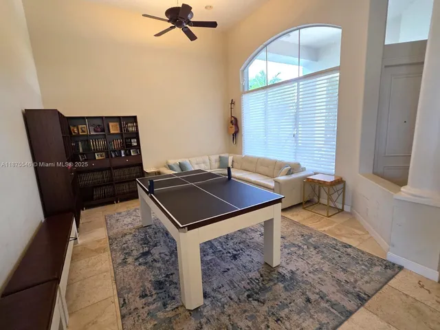 a living room with a table chairs and a rug
