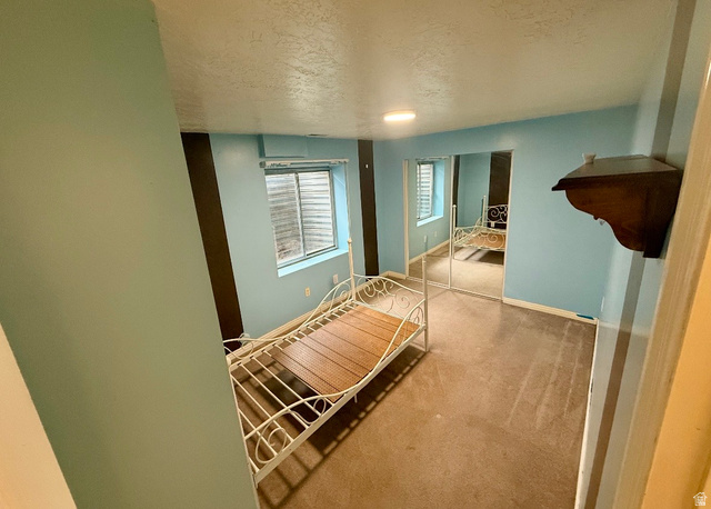 3918 Mapleleaf Way West Jordan, UT 84088 - Photo 4 of 12 Carpeted bedroom featuring a textured ceiling and a closet