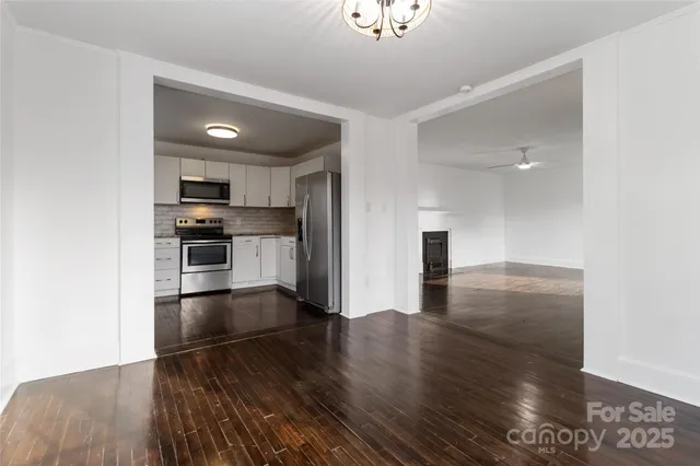 a kitchen with granite countertop a sink and steel appliances