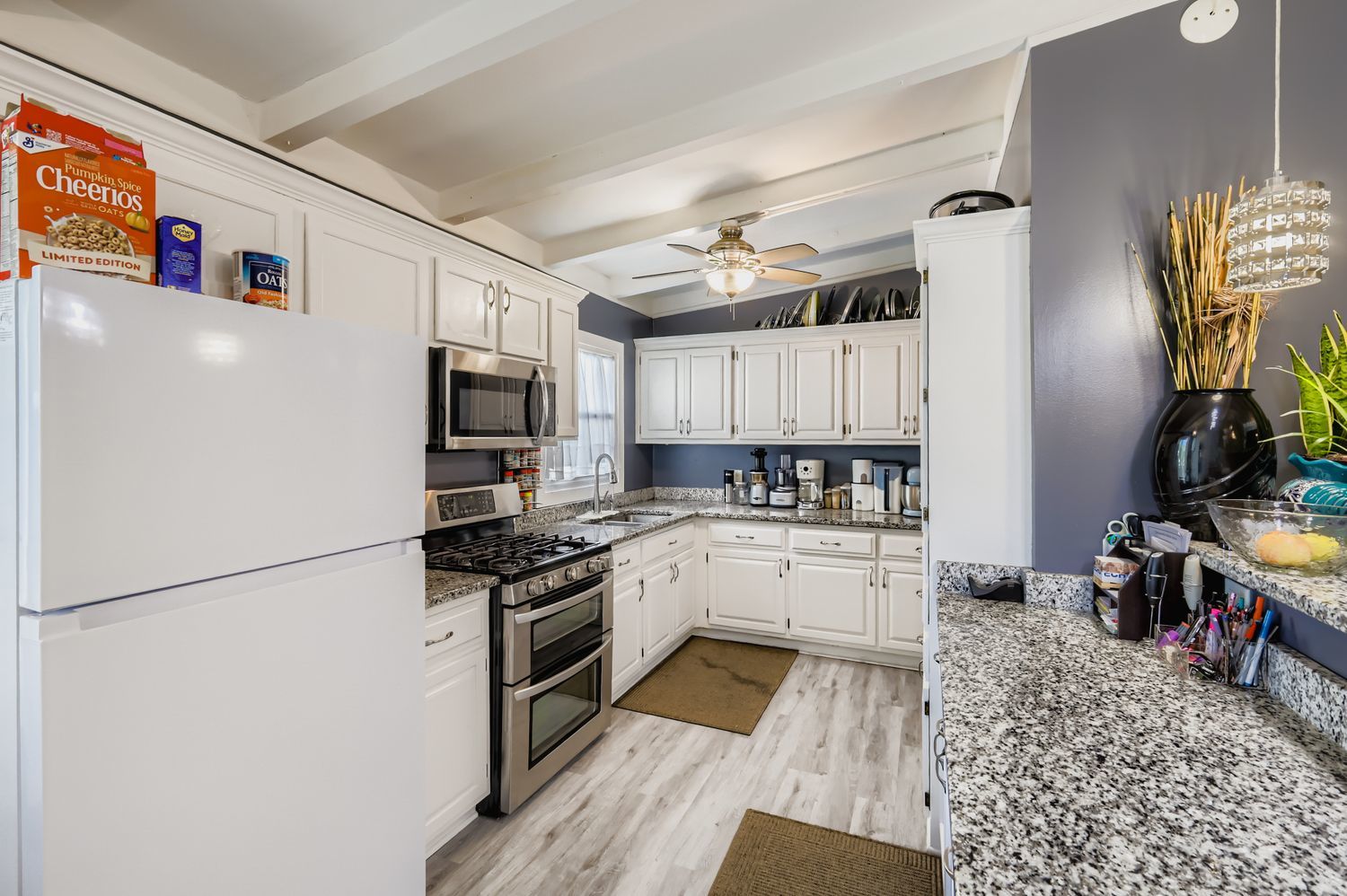19W720 Woodland Avenue Addison, IL 60101 - Photo 6 of 17 a kitchen with granite countertop a refrigerator and a stove top oven