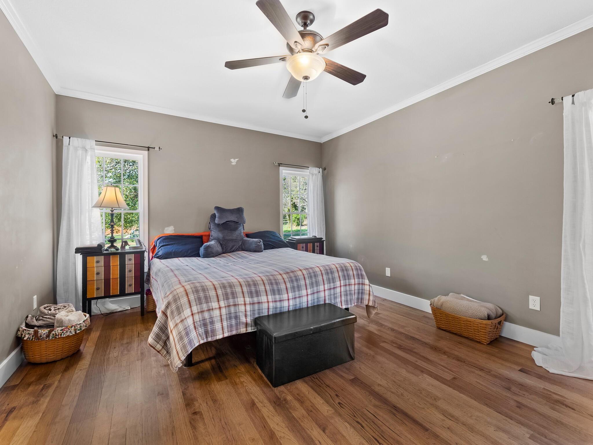 480 Meadowview Drive Saluda, NC 28773 - Photo 15 of 44 a bedroom with a bed and wooden floor