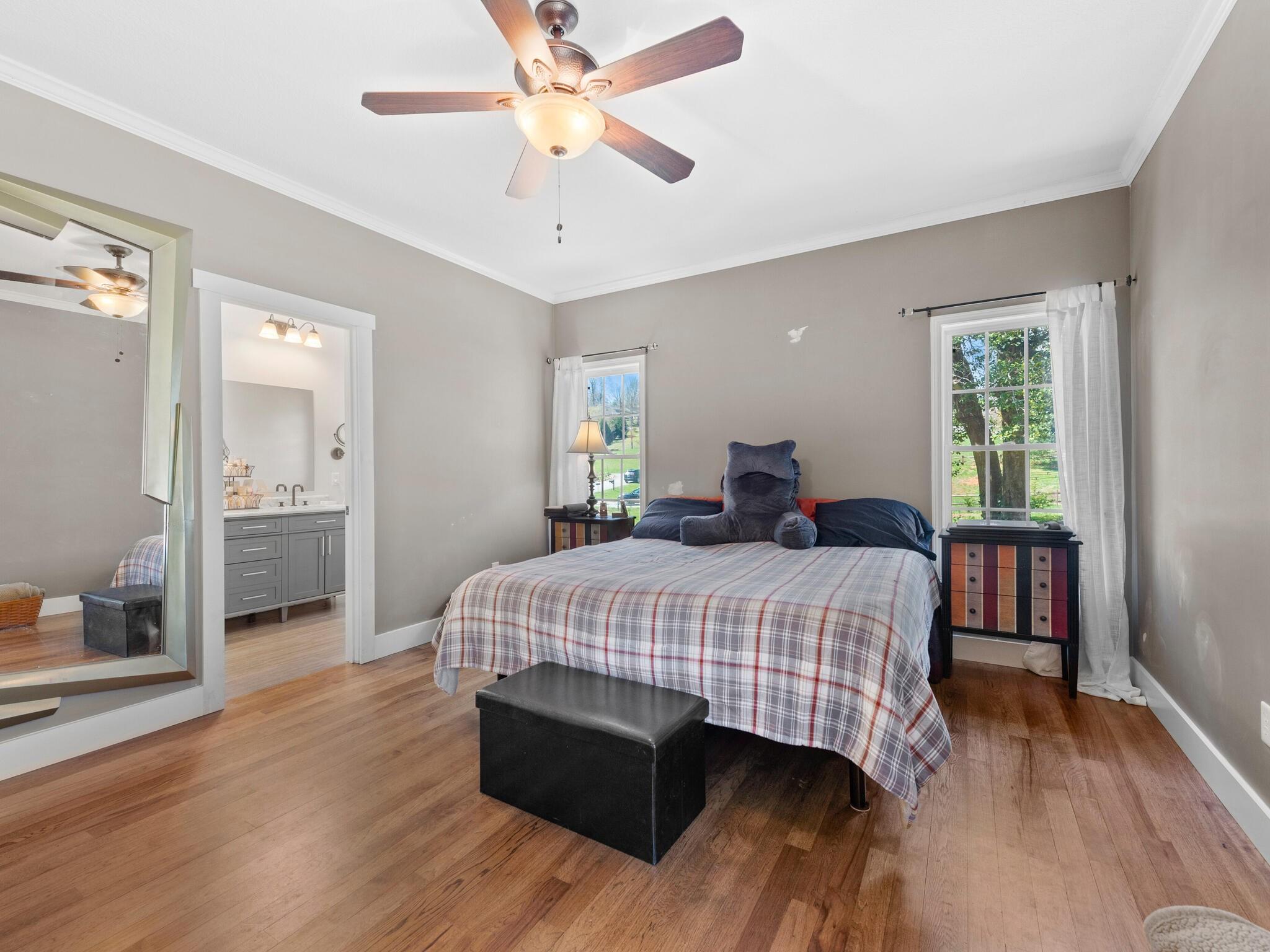 480 Meadowview Drive Saluda, NC 28773 - Photo 16 of 44 a bedroom with a bed and wooden floor