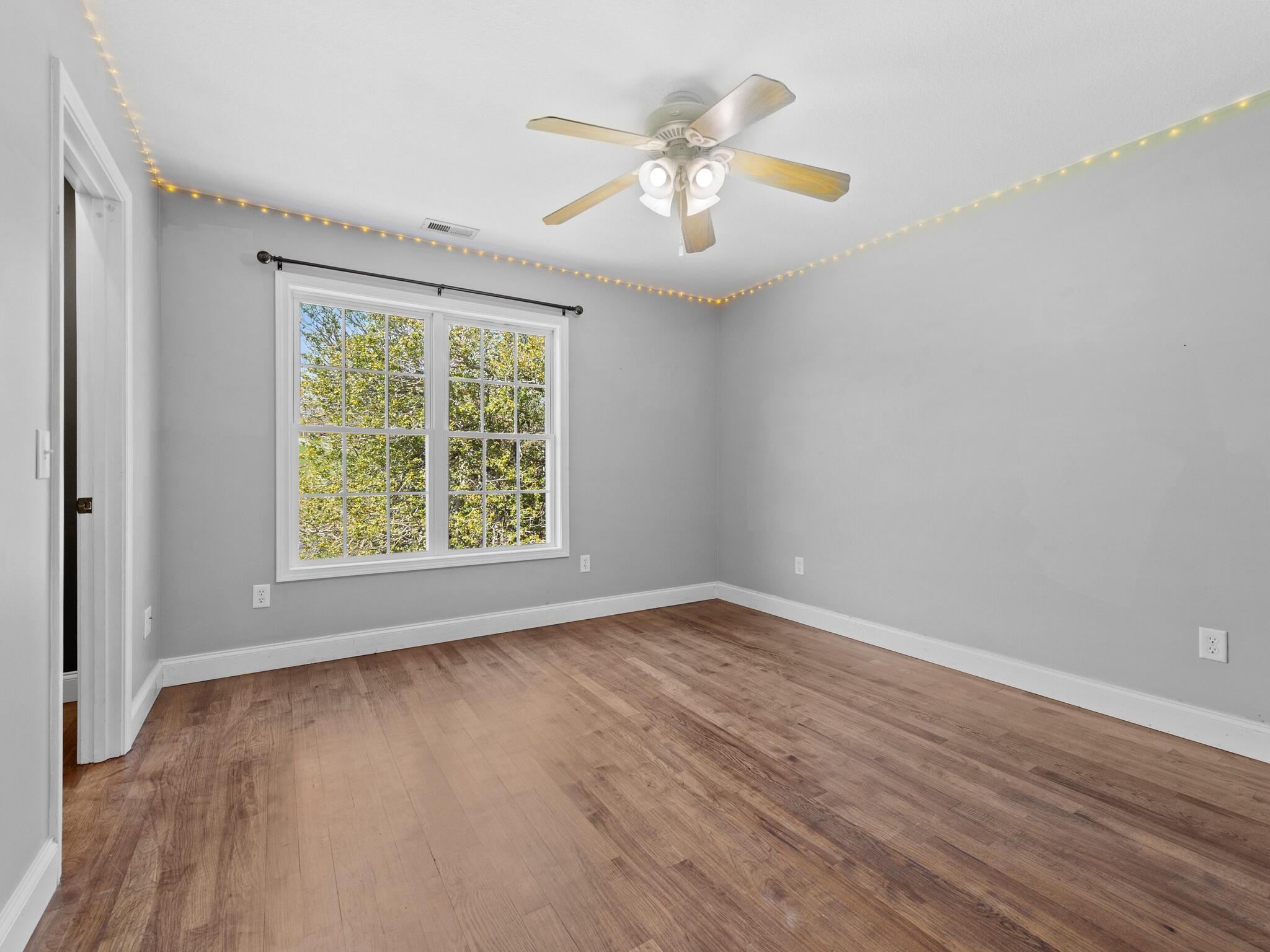 480 Meadowview Drive Saluda, NC 28773 - Photo 20 of 44 an empty room with wooden floor and windows