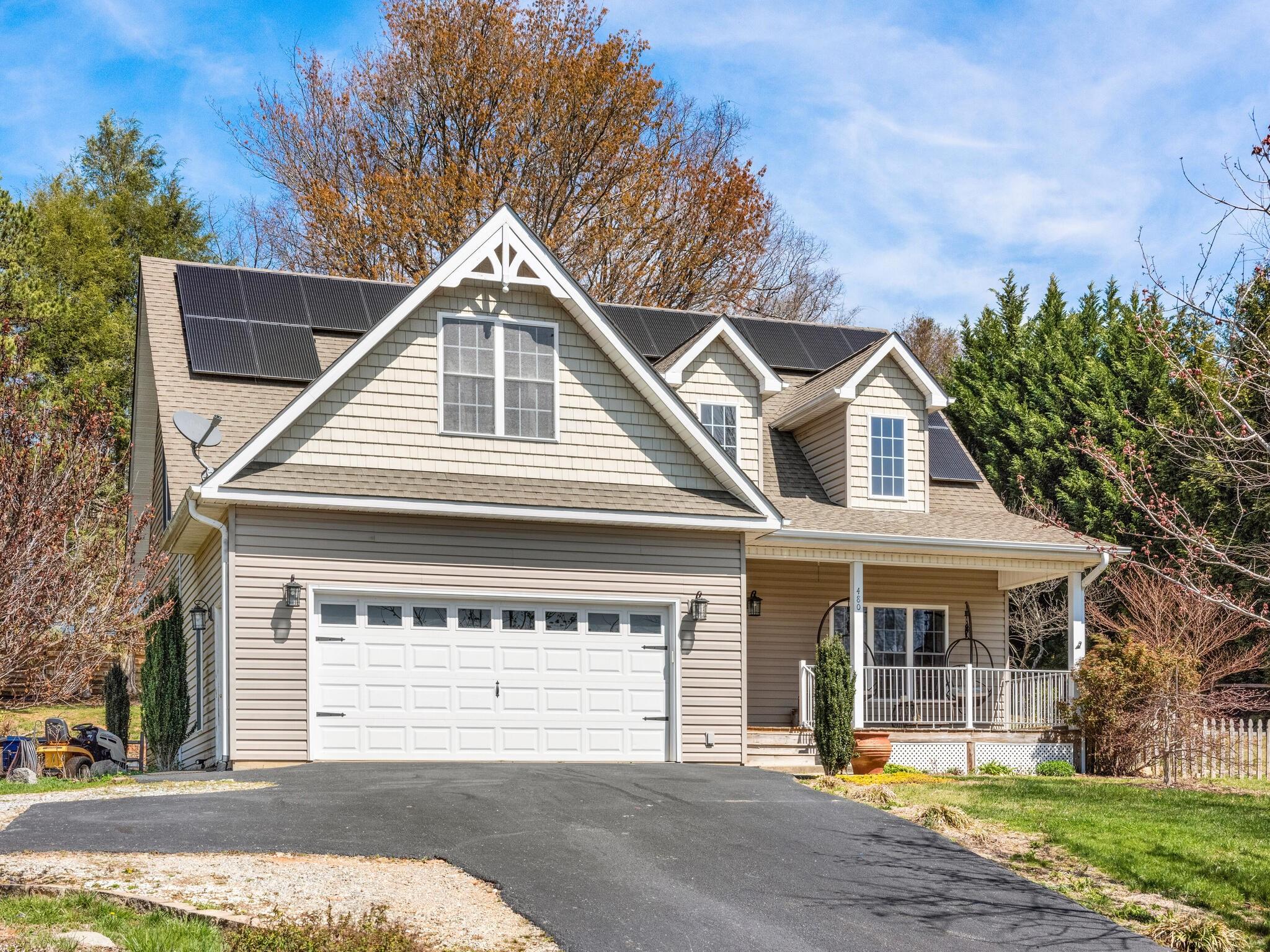 480 Meadowview Drive Saluda, NC 28773 - Photo 2 of 44 a front view of a house with a yard and garage