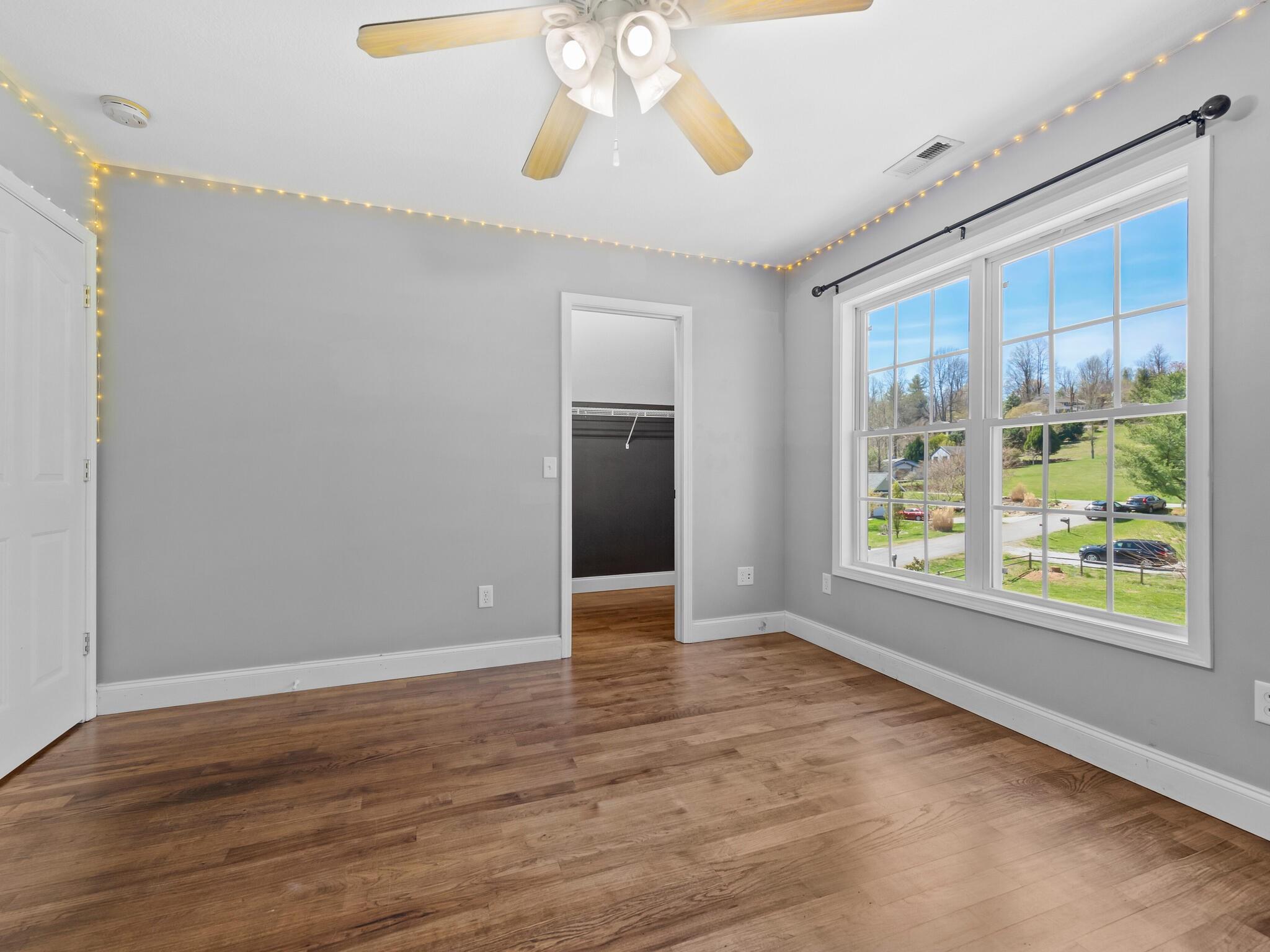480 Meadowview Drive Saluda, NC 28773 - Photo 22 of 44 a view of an empty room with wooden floor and a window