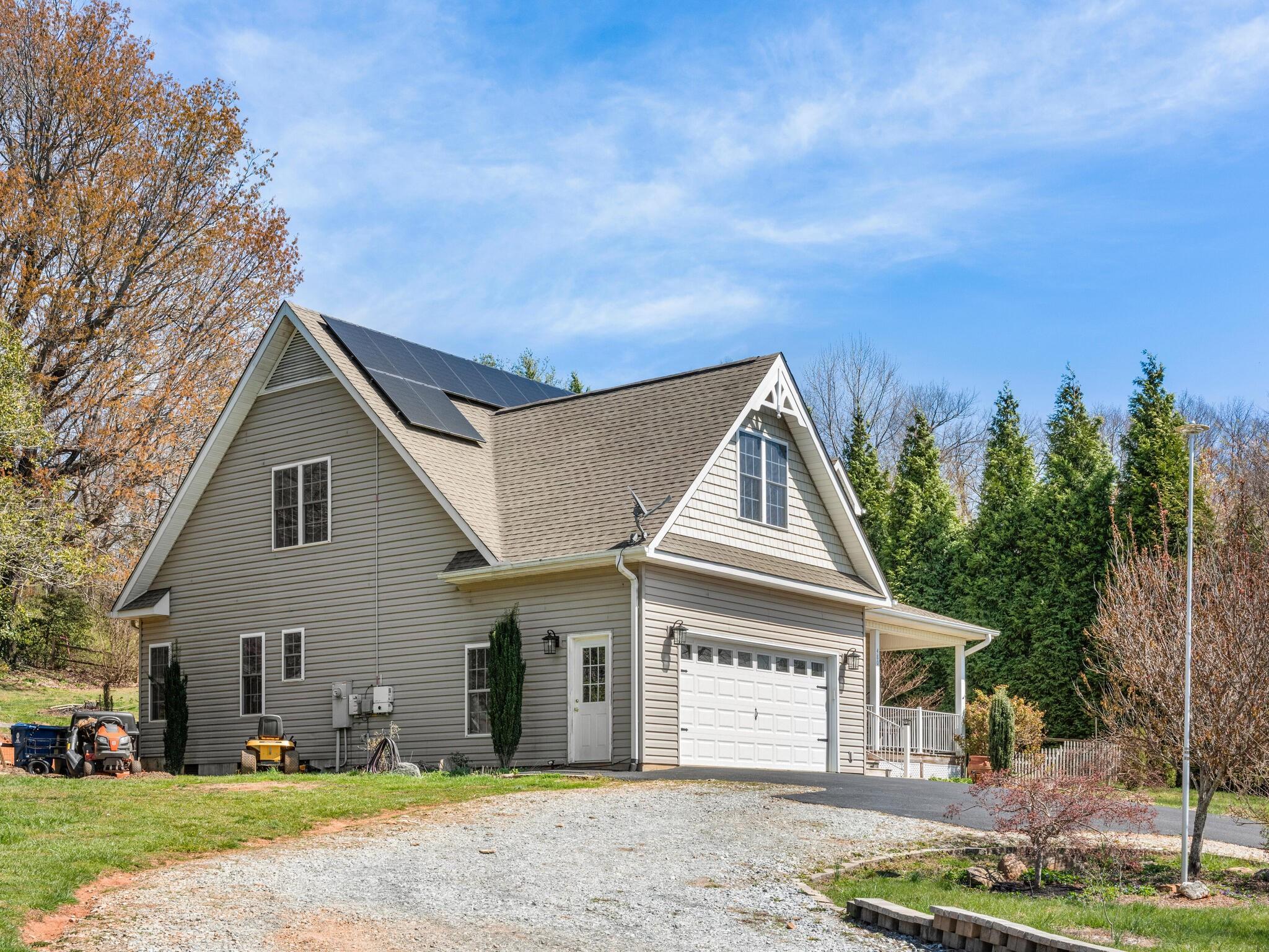 480 Meadowview Drive Saluda, NC 28773 - Photo 29 of 44 a view of a white house with a yard and large tree