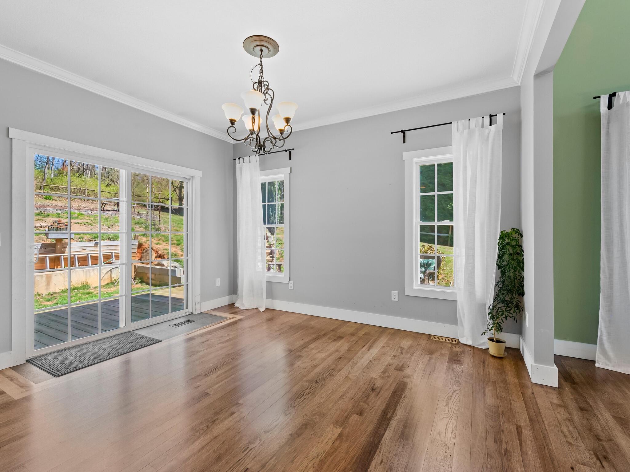 480 Meadowview Drive Saluda, NC 28773 - Photo 10 of 44 an empty room with wooden floor and windows