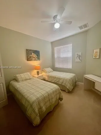a bedroom with two beds and painting on the wall