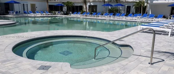a view of an house with swimming pool and chairs