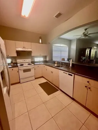 a kitchen with stainless steel appliances granite countertop a sink and cabinets