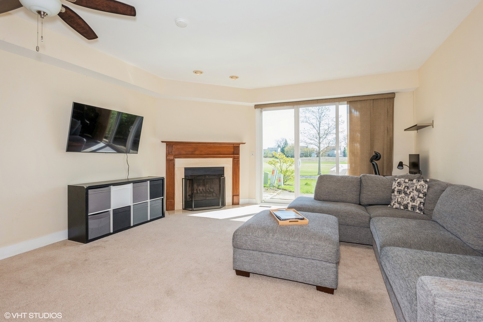 1475 Golfview Drive Glendale Heights, IL 60139 - Photo 7 of 17 a living room with furniture a flat screen tv and a fireplace