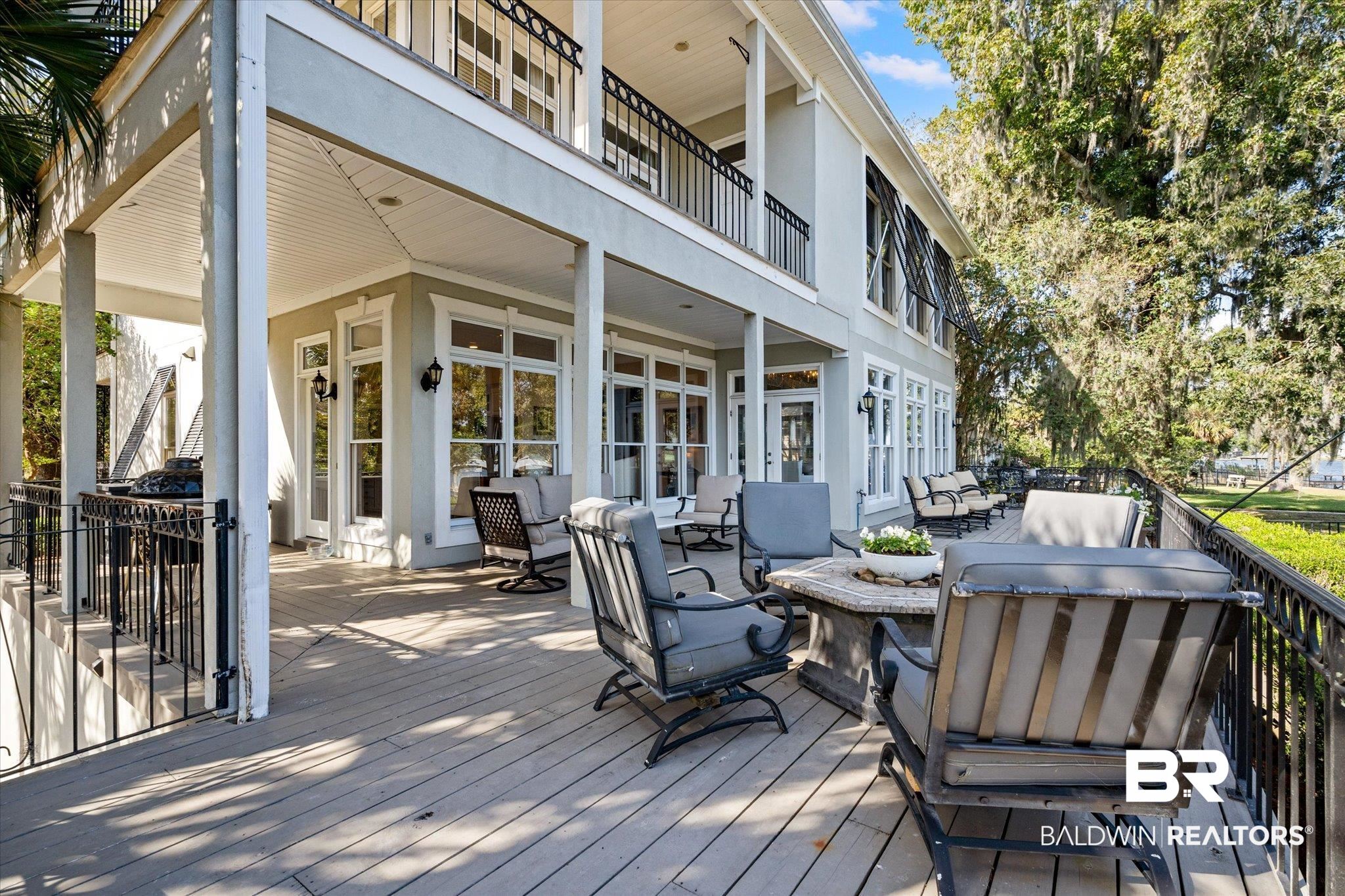 4930 River Trace Theodore, AL 36582 - Photo 6 of 57 Wooden terrace with french doors and an outdoor living space with a fire pit