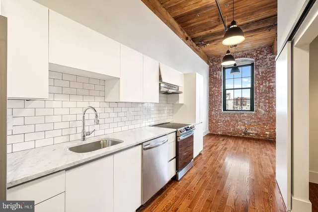 a kitchen with a sink stove and cabinets