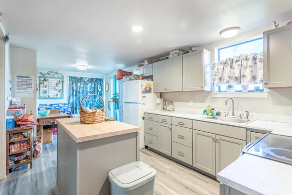 a kitchen with a sink a stove and cabinets