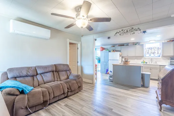 a living room with furniture and kitchen view