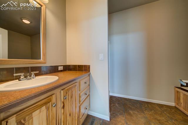 13615 Mc Cune Road Elbert, CO 80106 - Photo 31 of 31 Single Vanity in Primary Bath w/hickory cabinet & drawers